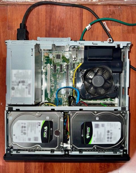 Open HP EliteDesk NAS chassis showing the internal components and two installed data drives